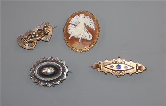 A 9ct gold mounted cameo brooch, a 9ct bar brooch and two other brooches including a late Victorian silver mourning brooch.